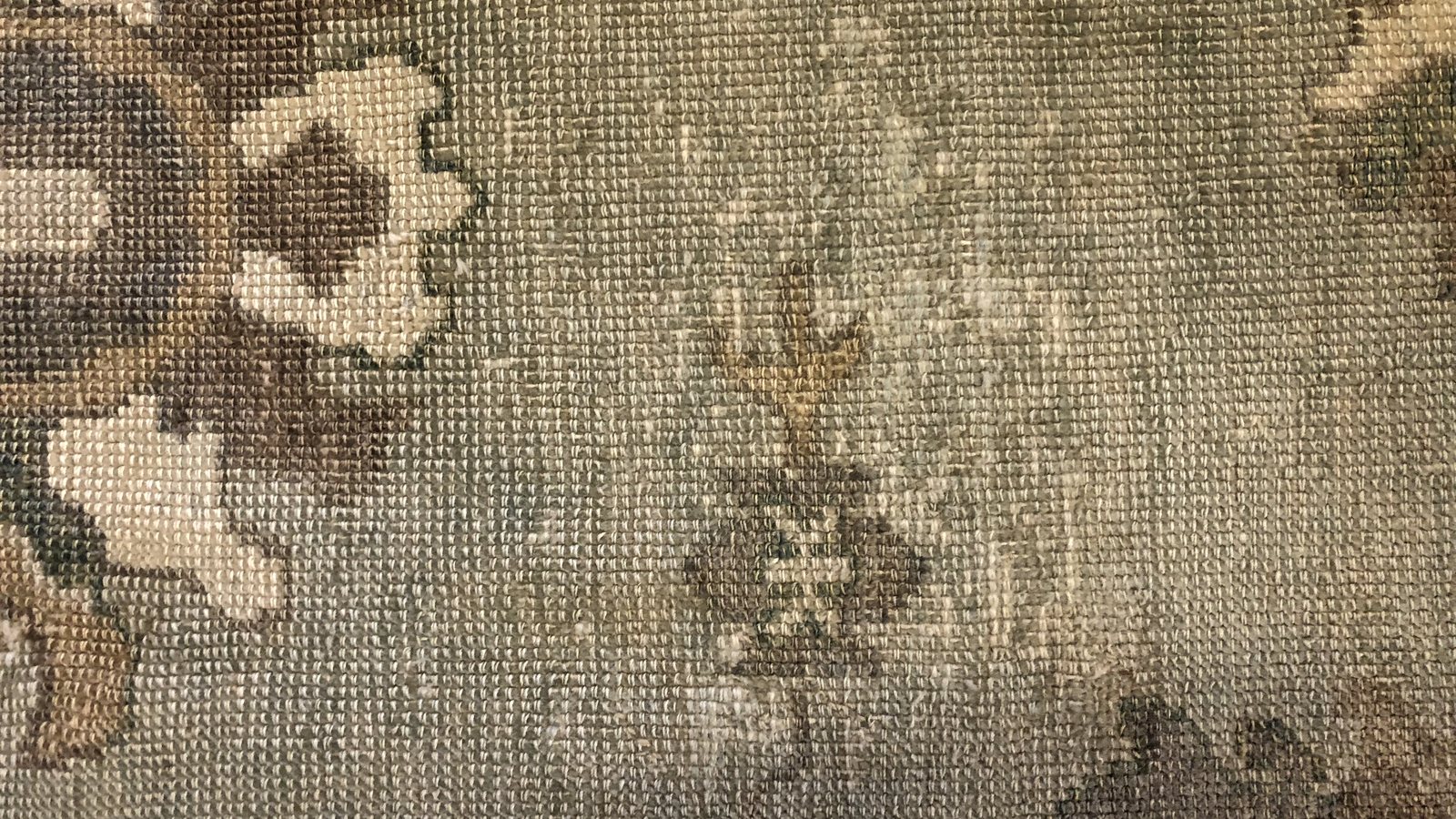 Close view of rug knots on the foundation, where fine silt and sand collect out of sight